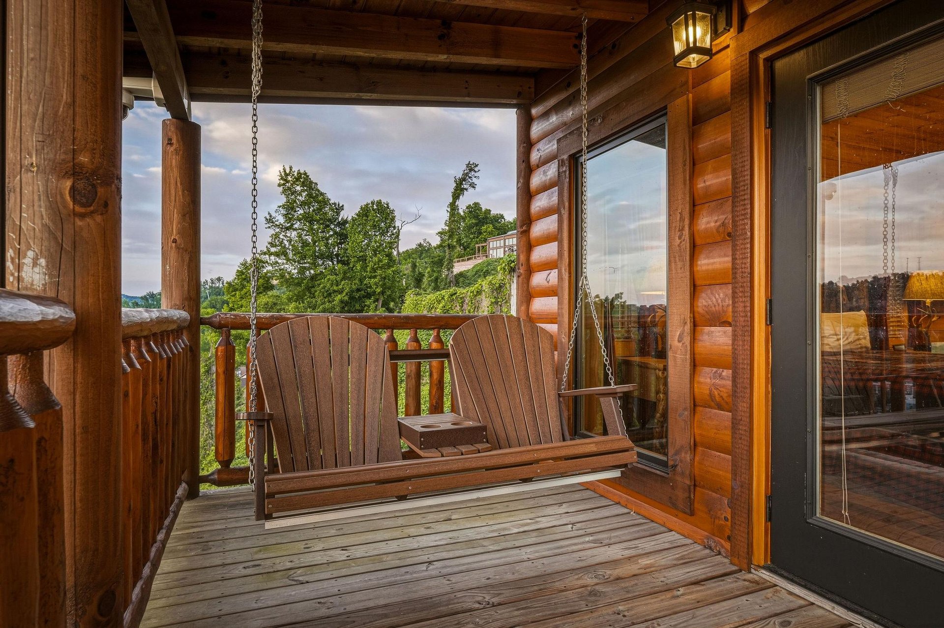 Settle into the porch swing and let your worries drift away as you gaze across the peaceful countryside, surrounded by warm wood tones and natural beauty.