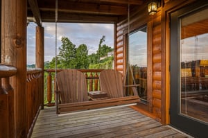 Settle into the porch swing and let your worries drift away as you gaze across the peaceful countryside, surrounded by warm wood tones and natural beauty.