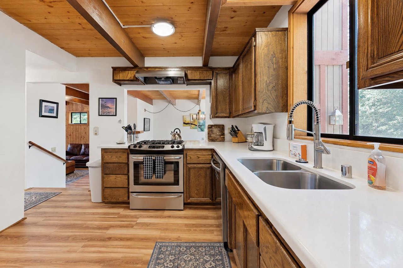 A second angle on the newly remodeled kitchen, with fresh countertops and an open flow into the living area, so no ones left out of the conversation while cooking.