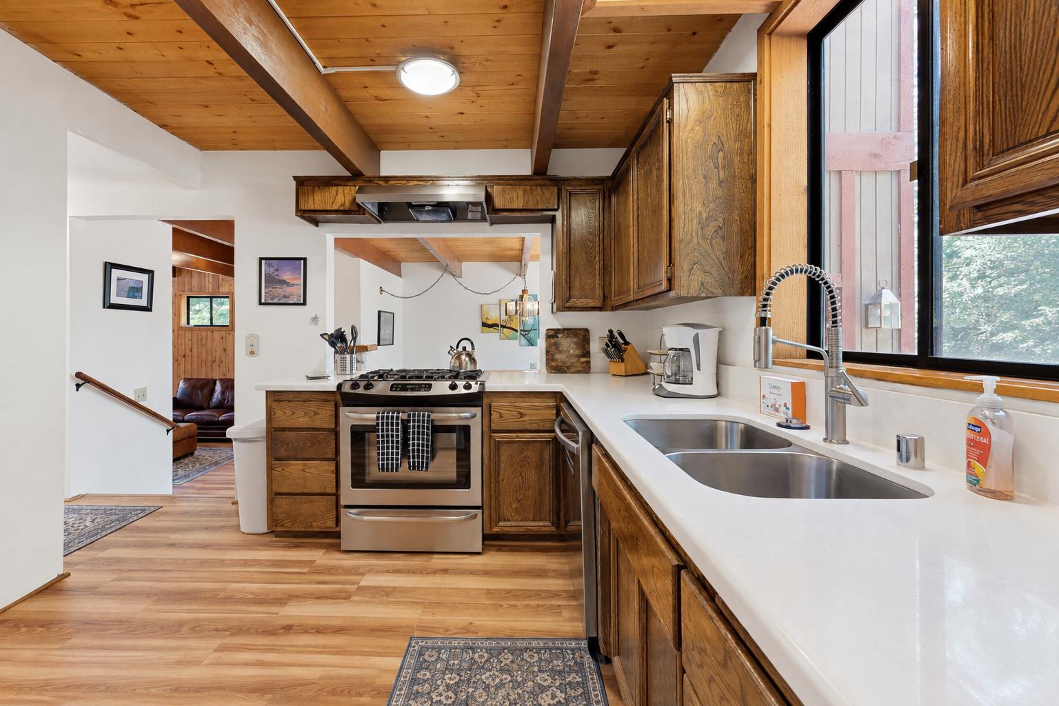 A second angle on the newly remodeled kitchen, with fresh countertops and an open flow into the living area, so no ones left out of the conversation while cooking.