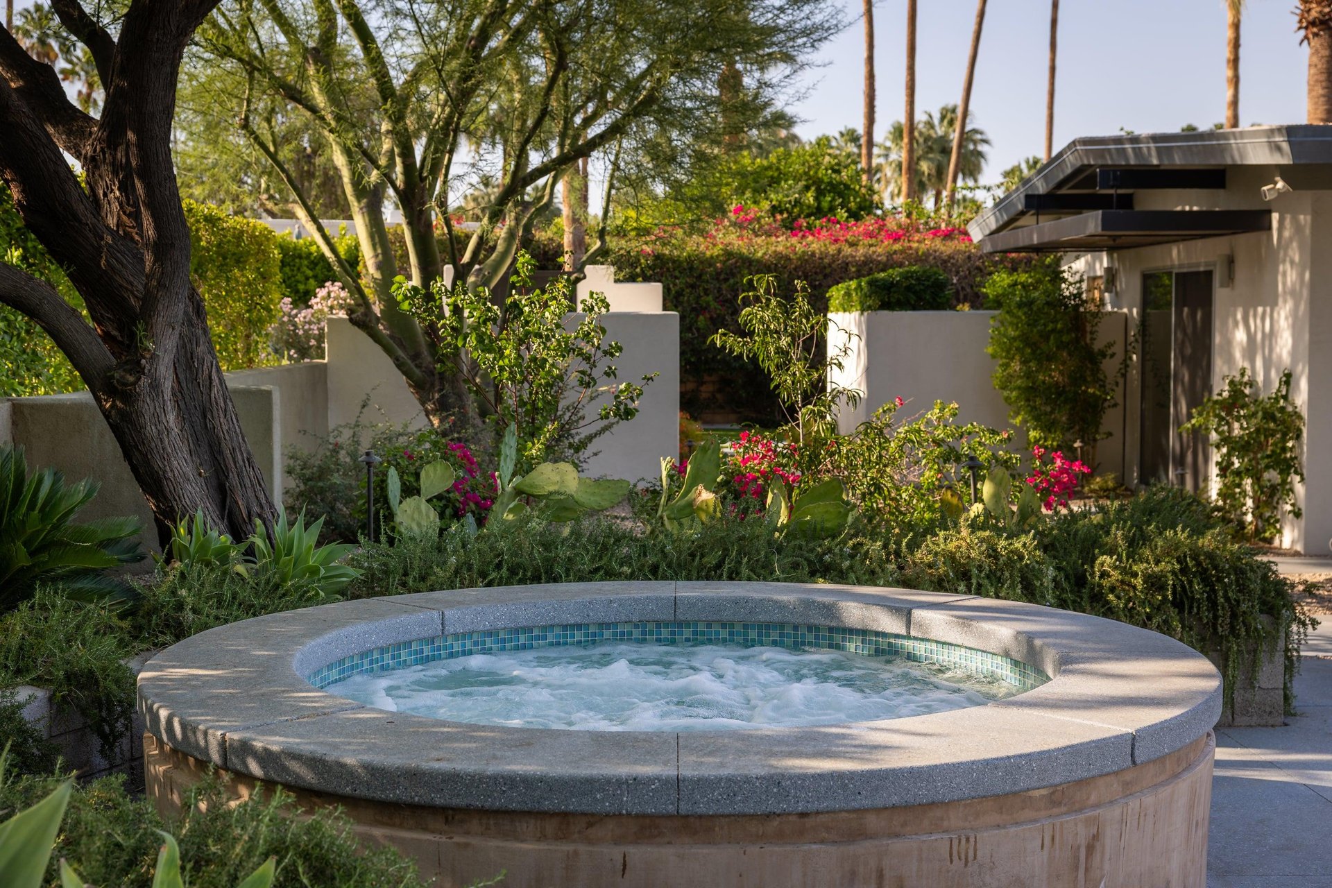 Private poolspa with sun loungers and umbrellas.