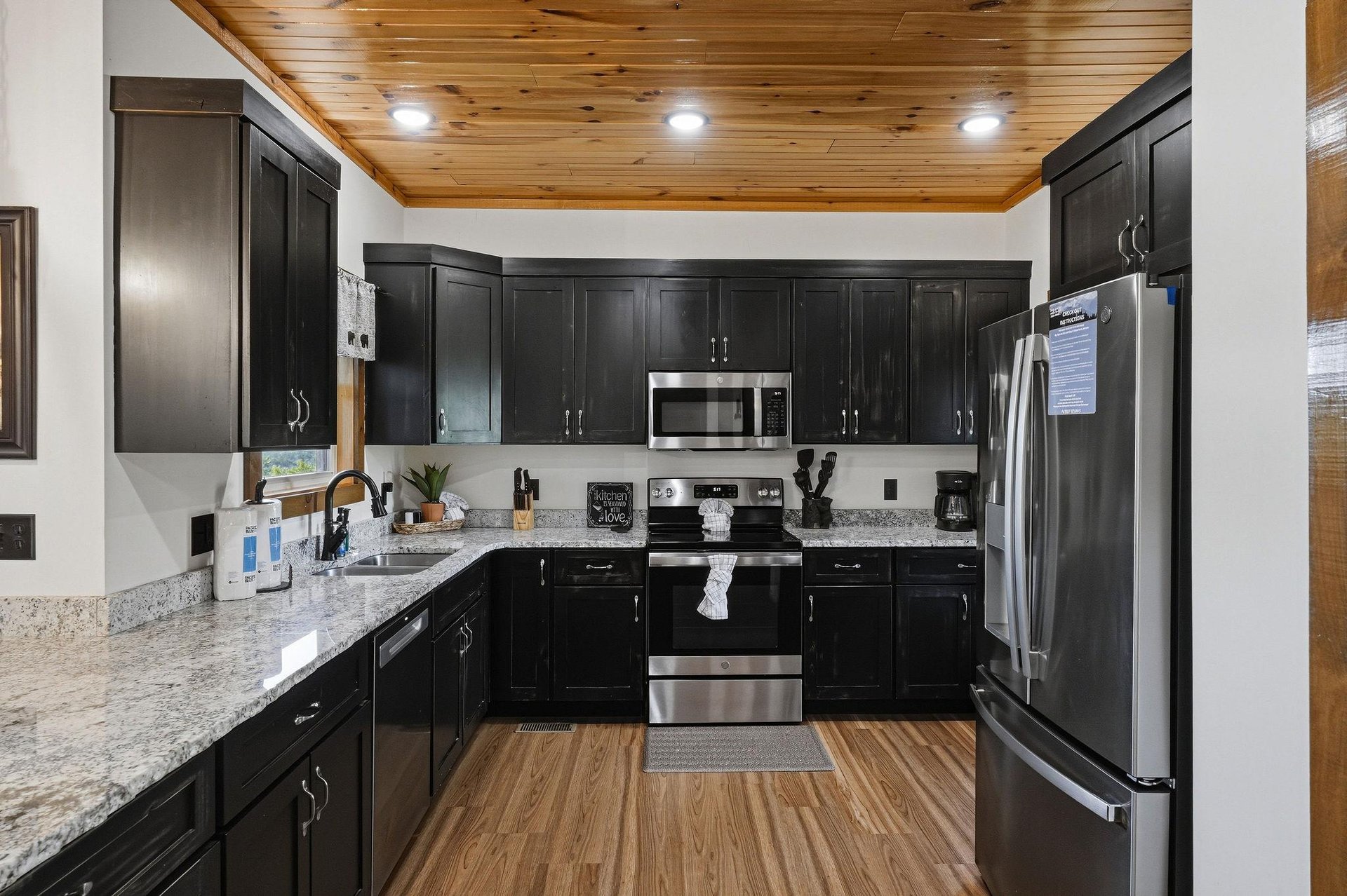 Prepare delicious meals in your spacious kitchen with granite countertops, stainless appliances, and warm wood ceiling. Everything you need for a relaxing stay is at your fingertips.