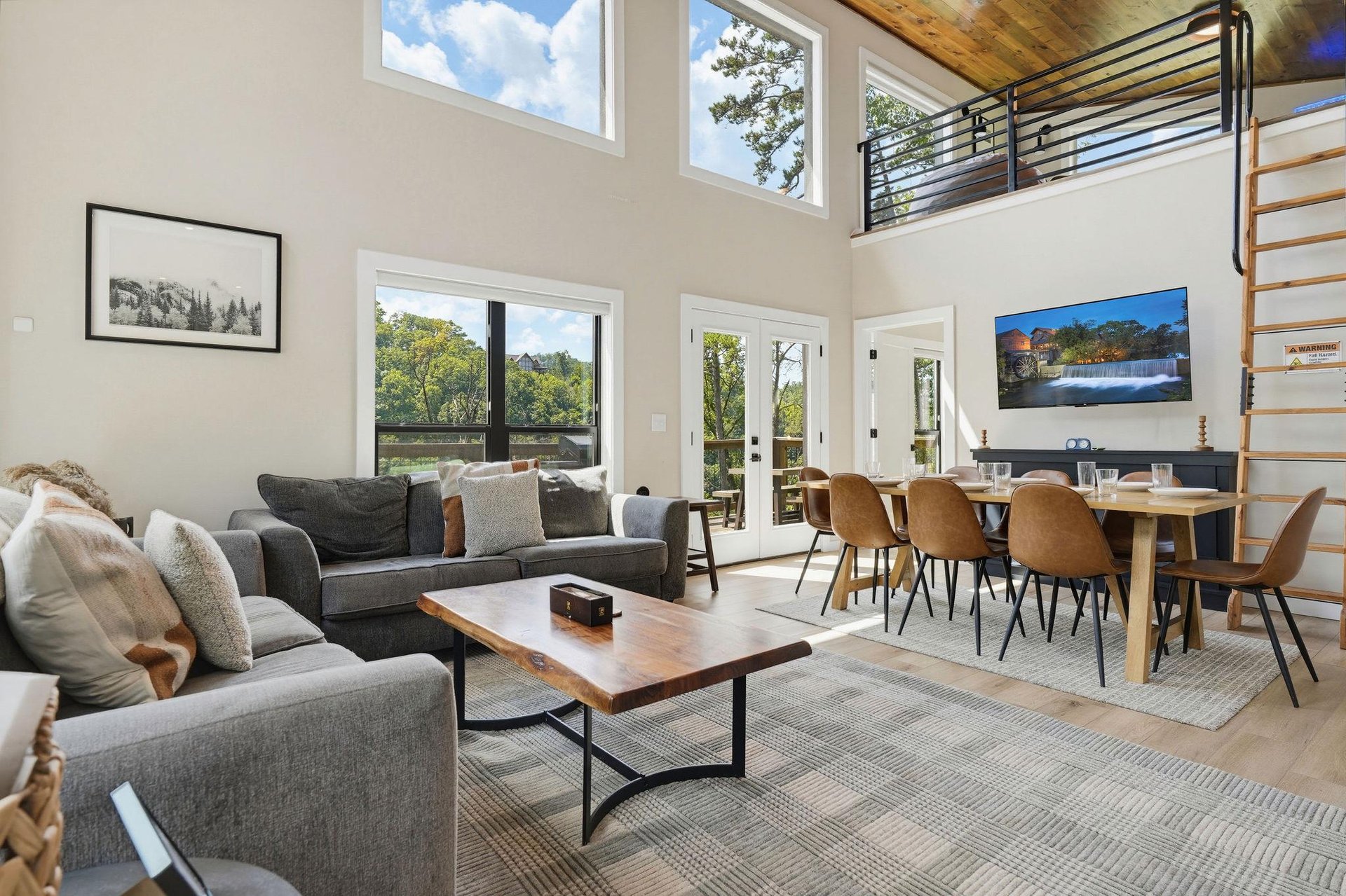 Sink into plush sofas and gather around the sleek dining table in this open, lightfilled space. Natural views frame your stay through floortoceiling windows.