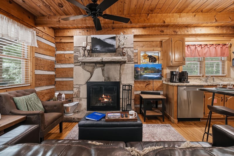 Curl up in your own rustic retreat with vaulted woodbeamed ceilings and a glowing stone fireplace. The open layout blends living, dining, and kitchen space so you can unwind completely.