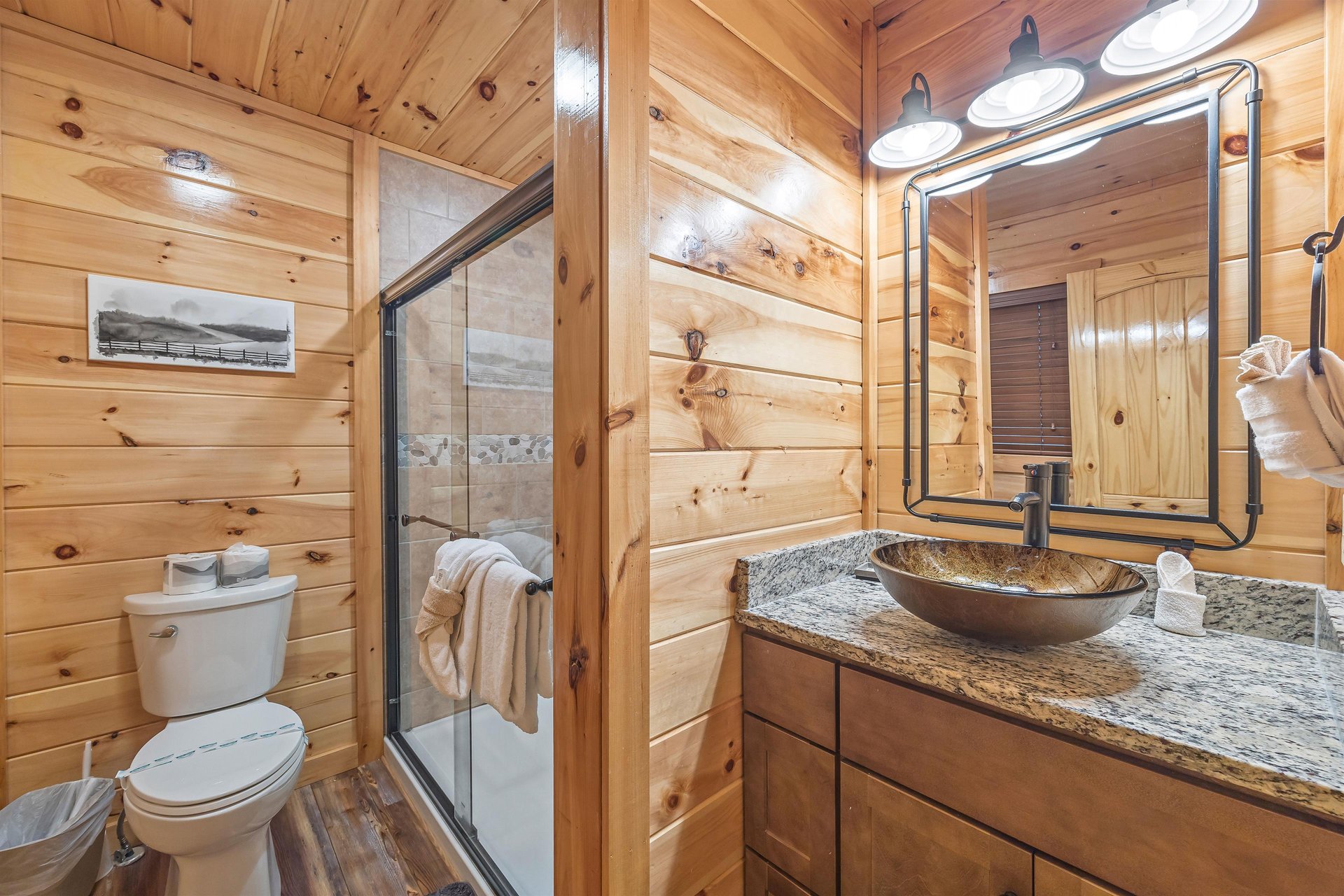 Walk in shower with divider wall to single vanity sink
