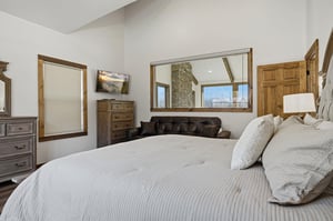 Drift off in your cozy bedroom featuring plush linens, rustic wood accents, and a comfy reading nook by the window.
