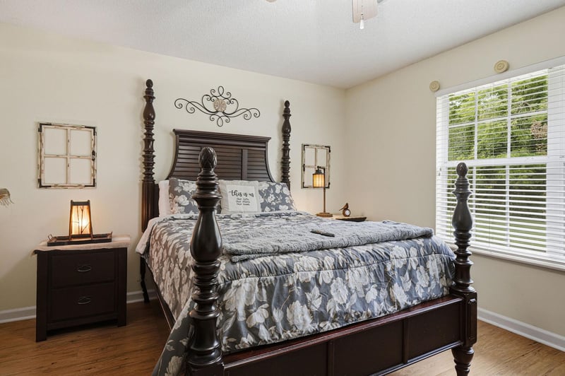 Sink into this elegant fourposter bed adorned with charming farmhouse décor, where soft natural light and rustic touches create your perfect retreat.