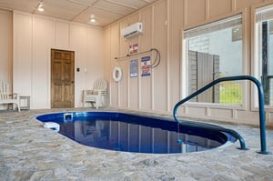 Dive into your private indoor pool anytime, with a handrail for easy access, climate control, and a cozy sitting area nearby.