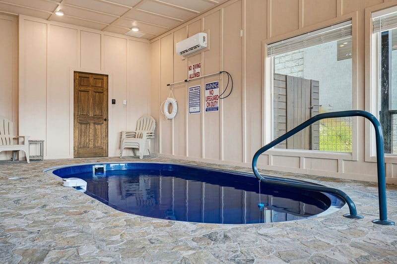 Dive into your private indoor pool anytime, with a handrail for easy access, climate control, and a cozy sitting area nearby.