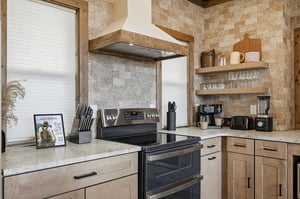 Youll love cooking in this warm, rustic kitchen with exposed brick walls, granite counters, and everything needed for your perfect meal.