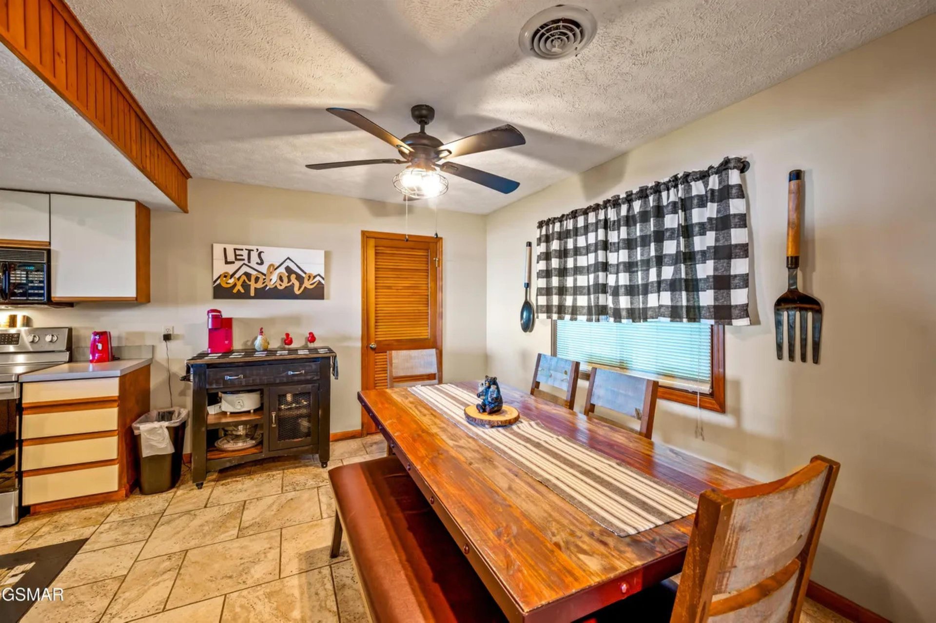 Gather around your rustic dining table where warm wood tones and cozy mountain vibes create the perfect spot for morning coffee or evening meals.