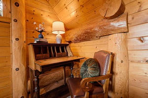 Your private workspace features warm wood paneling and handcrafted log beams, creating a rustic retreat where you can catch up on emails or journal about your mountain adventures.