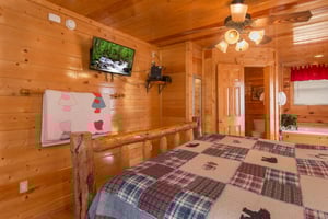 TV in a bedroom at Country Bears Getaway, a 3bedroom cabin rental located in Gatlinburg
