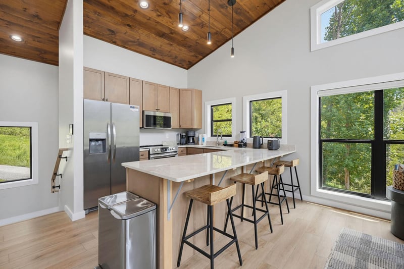 Step into your open kitchen bathed in natural light, where a spacious island invites you to gather over morning coffee or prepare meals together.