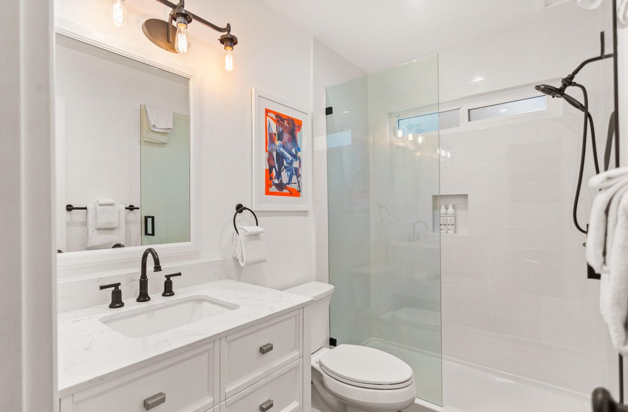 Full bathroom on the main floor, off of the kitchen and living room, with a walkin shower.