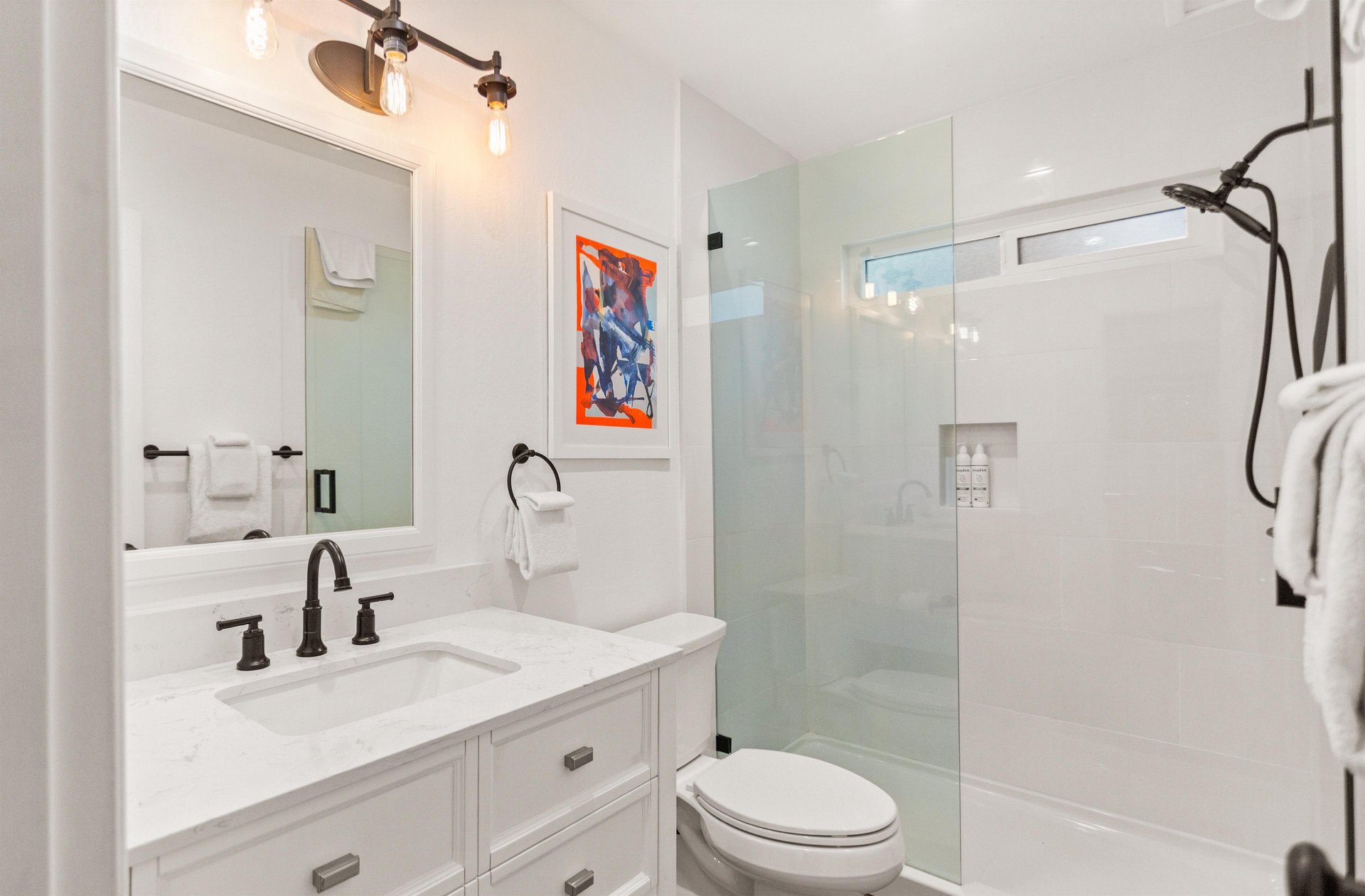 Full bathroom on the main floor, off of the kitchen and living room, with a walkin shower.