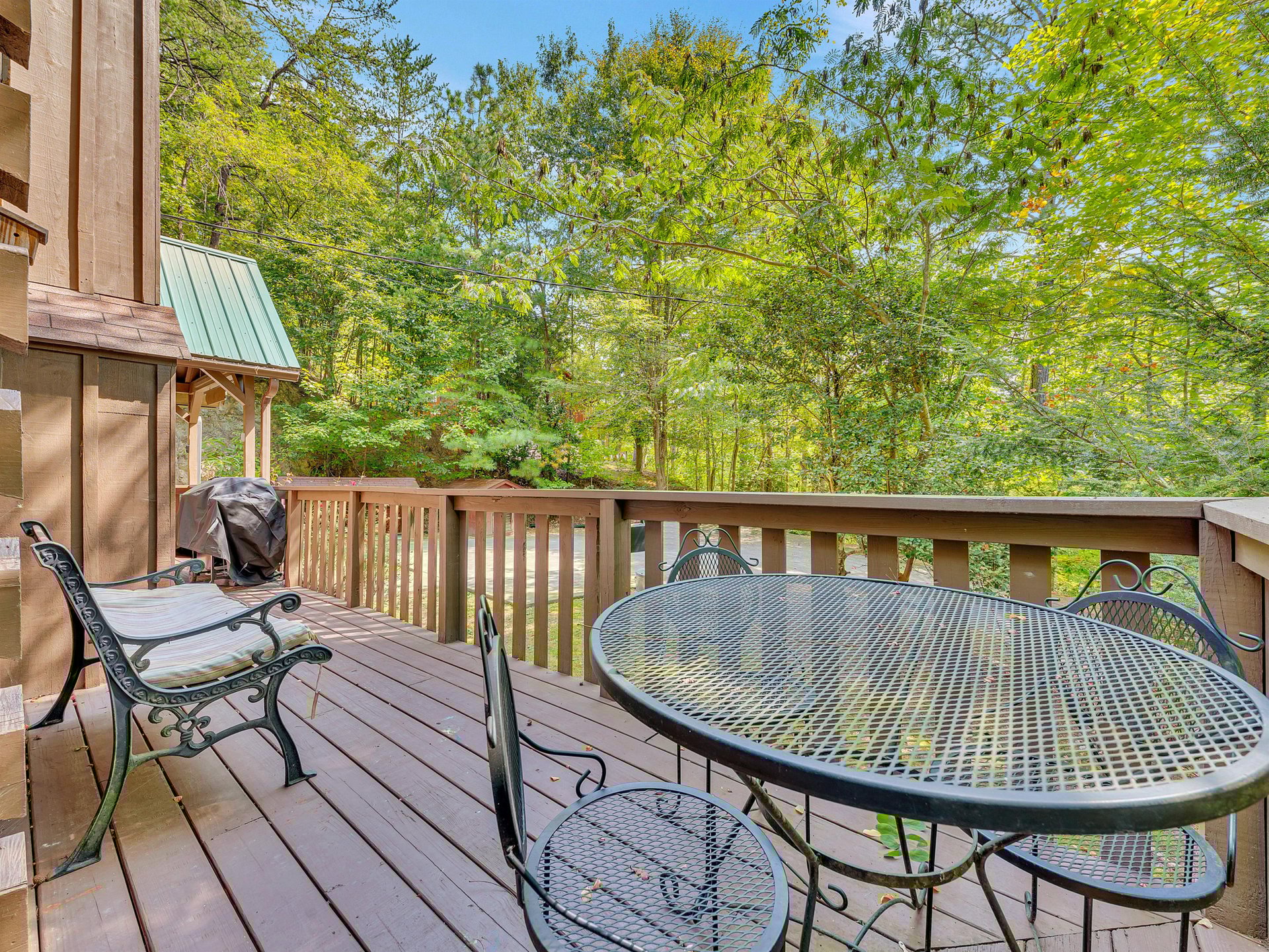 Sip your morning coffee on this peaceful deck, where forest views and comfortable seating create the perfect outdoor retreat.