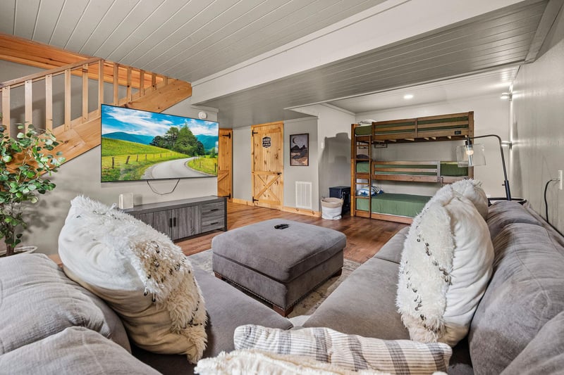 Living room with ottoman and triple bunk