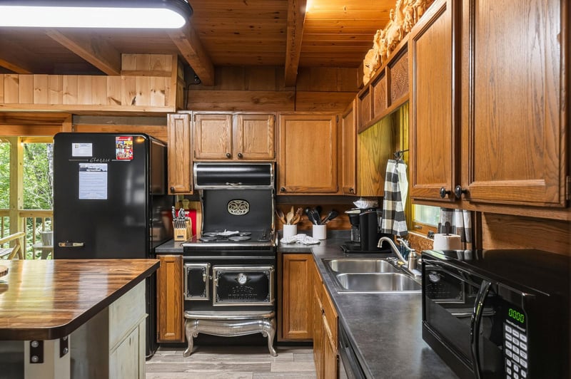Your fully equipped rustic kitchen blends vintage charm with modern convenience, featuring warm wood cabinetry, stainless steel sinks, and everything you need to cook up memorable meals during your st