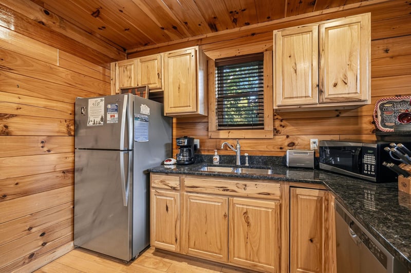 Your fully equipped kitchen features warm wood cabinetry, granite counters, and all the essentials—from the refrigerator and microwave to a coffee maker, so you can enjoy homecooked meals during your