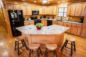 Full kitchen with island and stools
