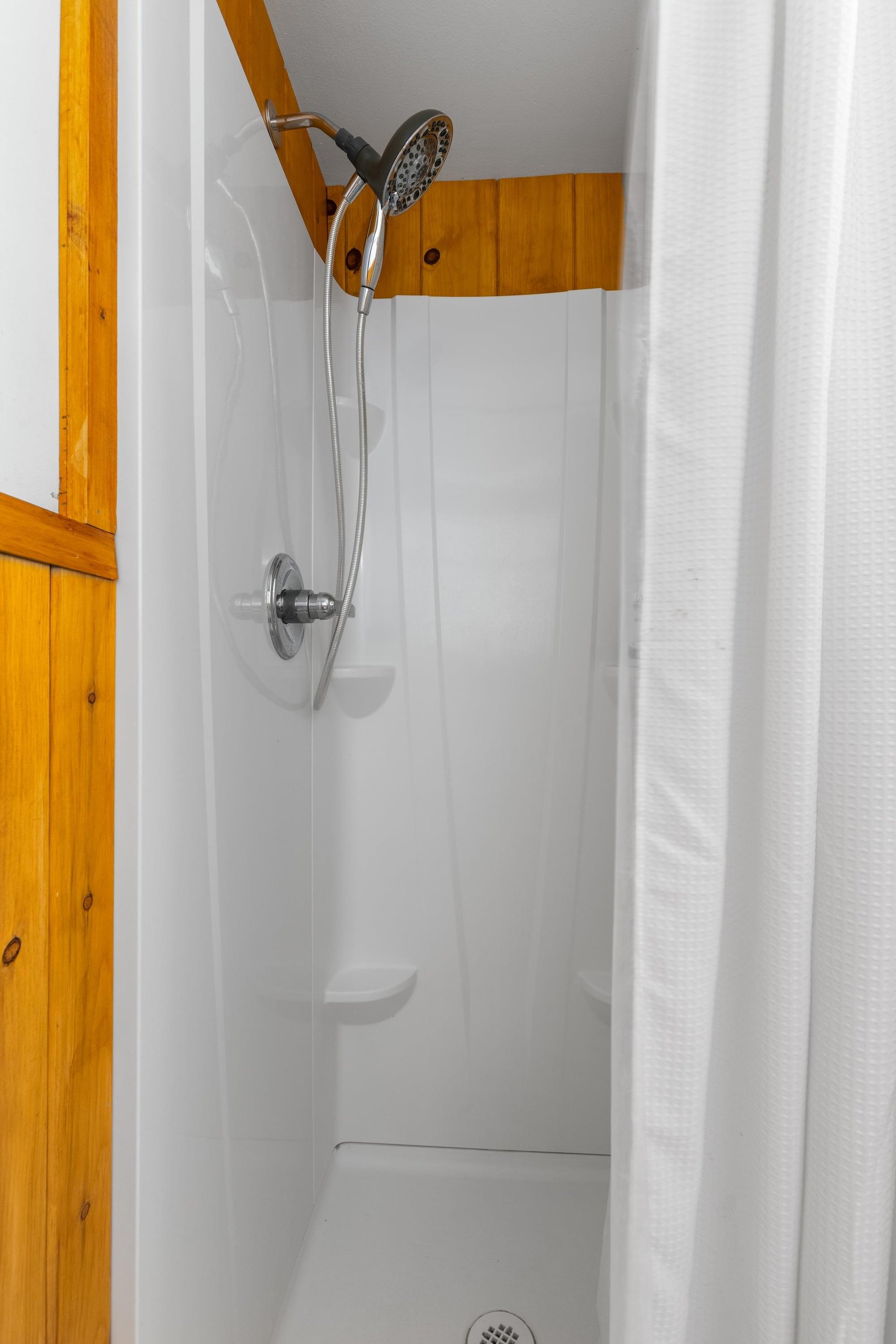 Ensuite bathroom with a walkin shower and detachable shower head.