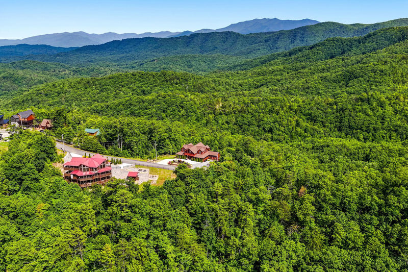 Nestled among lush forested mountains, the property offers a secluded escape with sweeping views of the surrounding natural landscape and distant peaks.