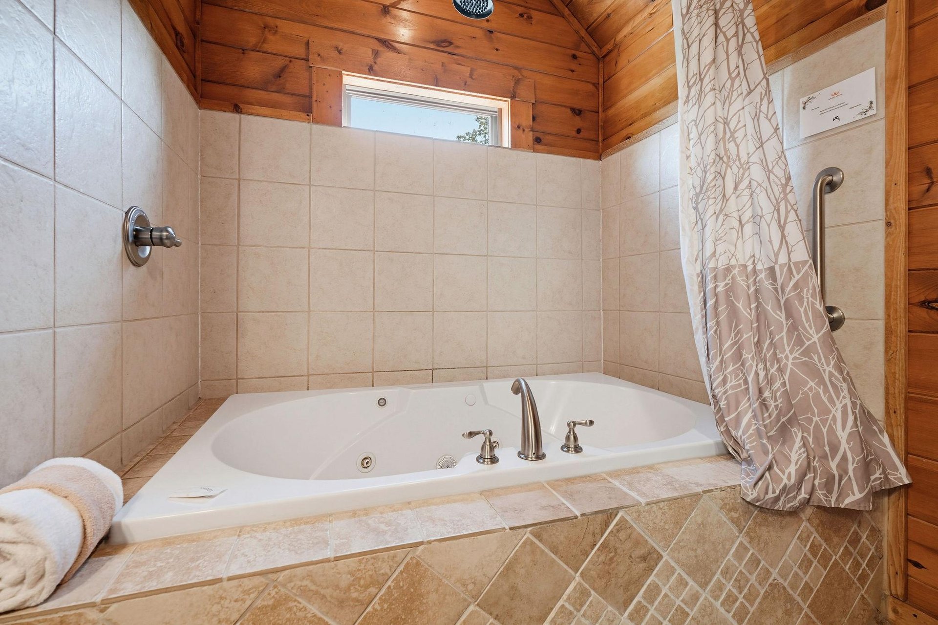 Sink into the warmth of your private jetted tub, where soft towels and peaceful cabin charm invite you to unwind completely after a day exploring.