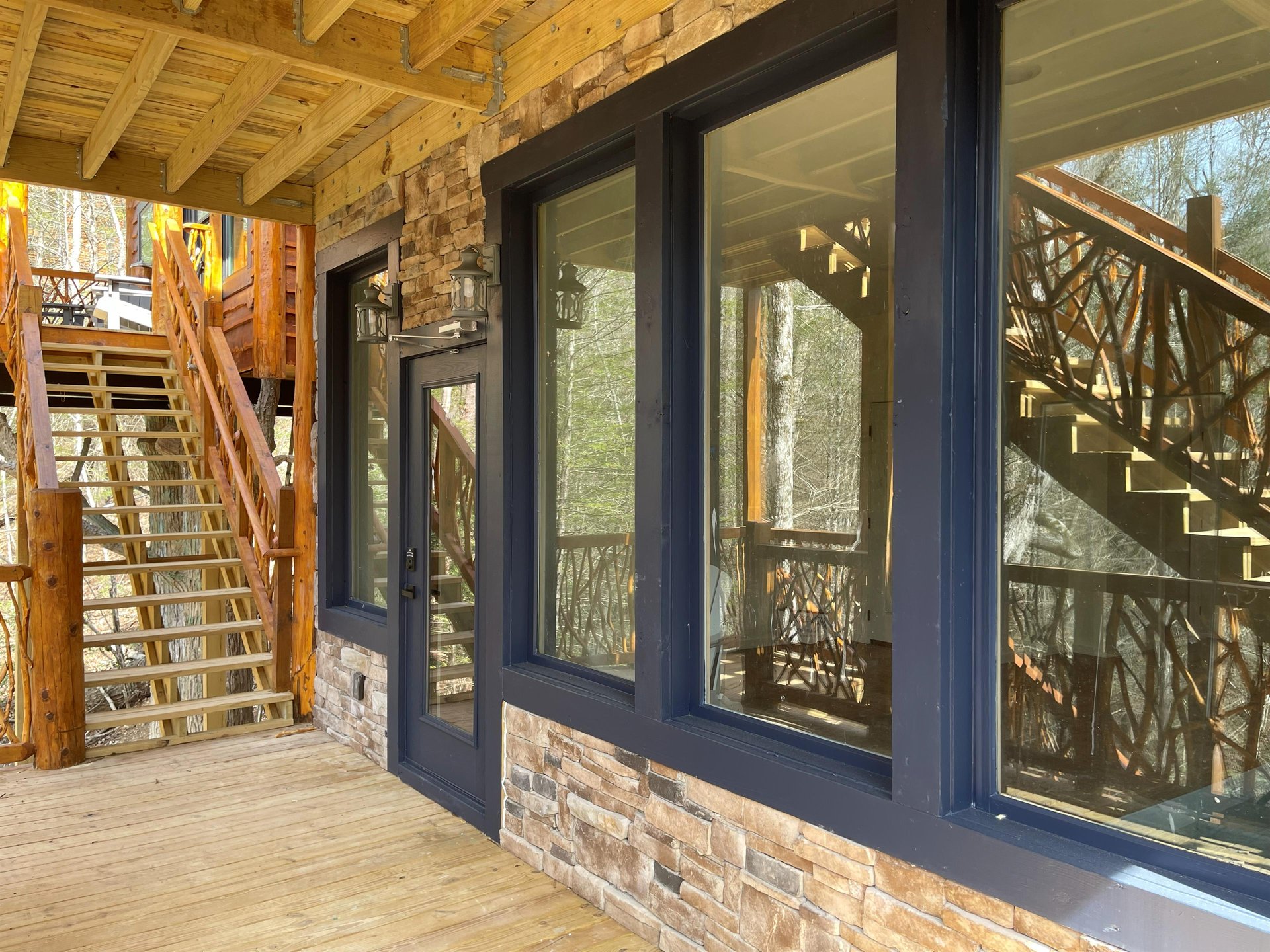 Step onto your private deck where rustic wood meets modern comfort, surrounded by peaceful forest views.