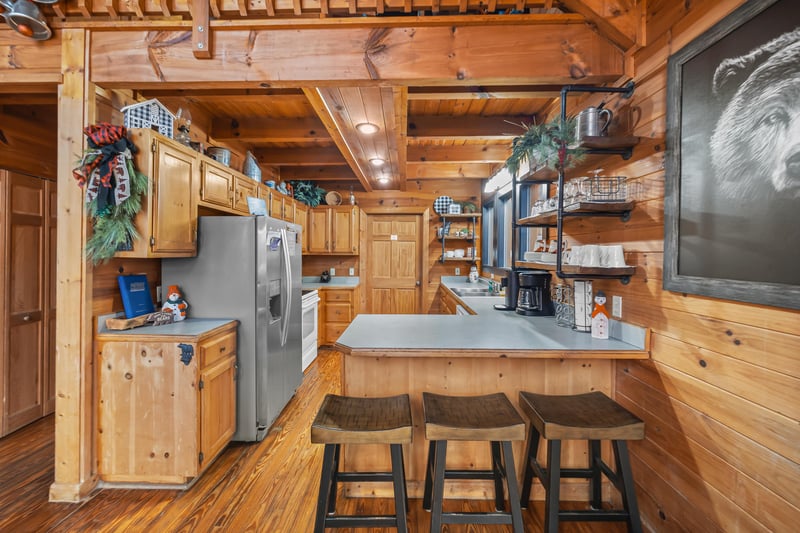 Full kitchen with stools at bar