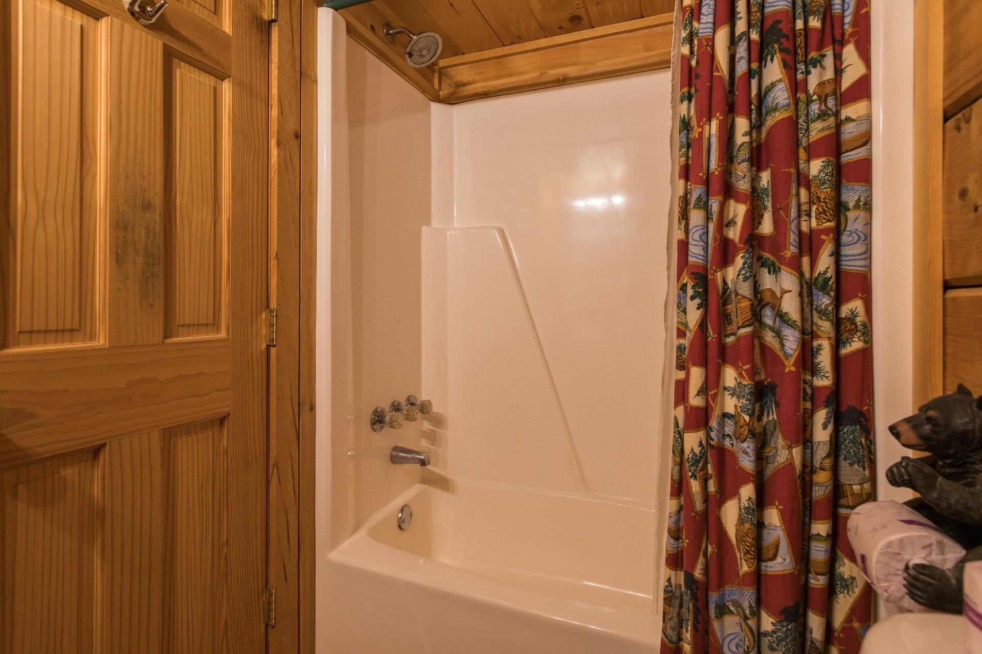 Bathroom with a tub and shower at Boogie Bear, a 1bedroom cabin rental located in Gatlinburg