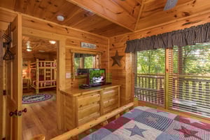 Dresser and TV in a bedroom at Graceland, a 4bedroom cabin rental located in Pigeon Forge