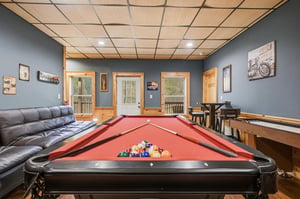 Your game room awaits with a fullsize pool table, comfy seating, and bonus game tables for endless entertainment.