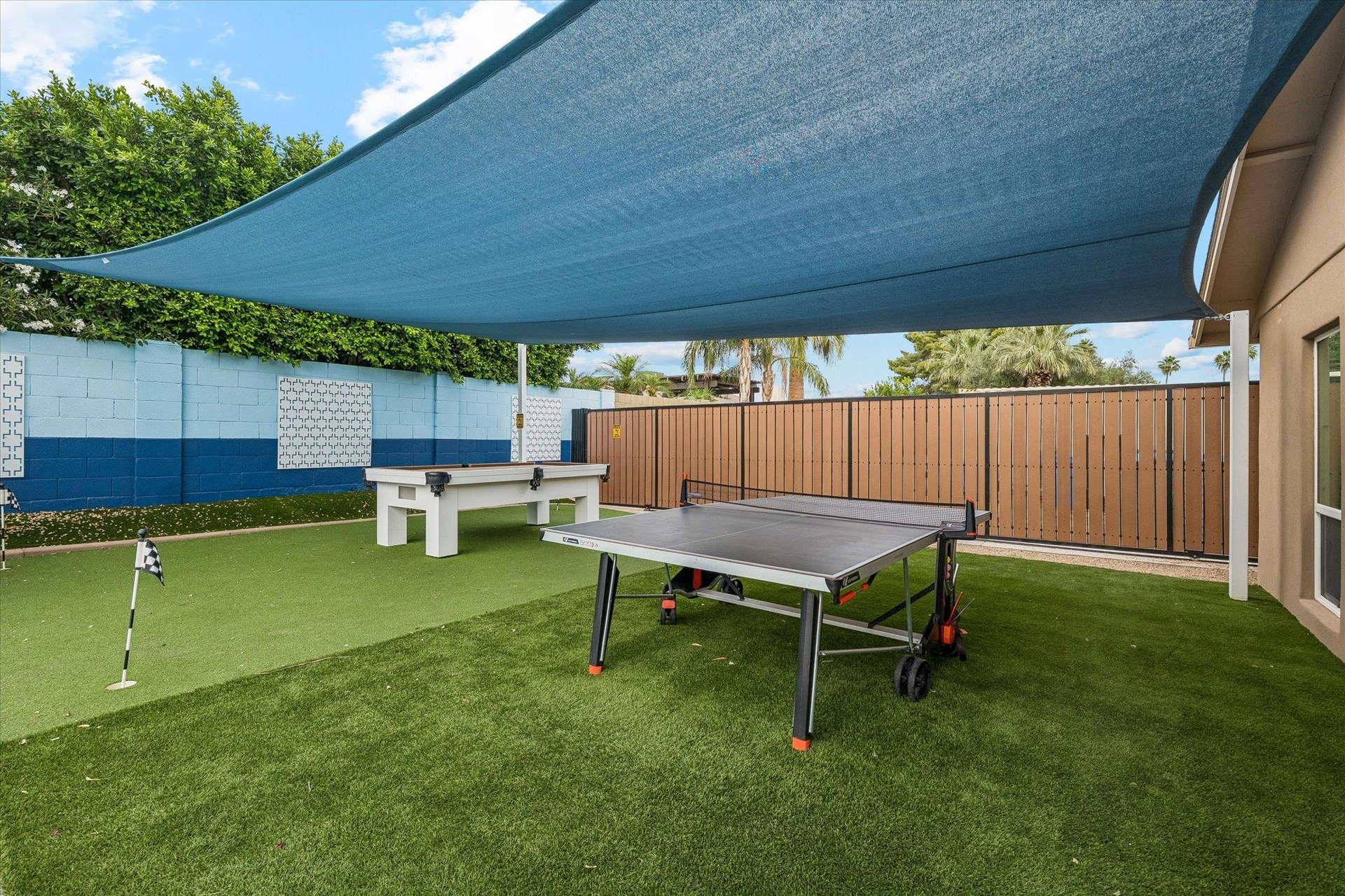 Sunsails, ping pong table, mini golf putting green, and pool table.