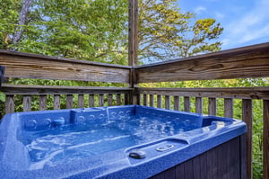 Soak in the warm, bubbling jets surrounded by leafy treetops—your private hot tub retreat awaits on this peaceful deck.