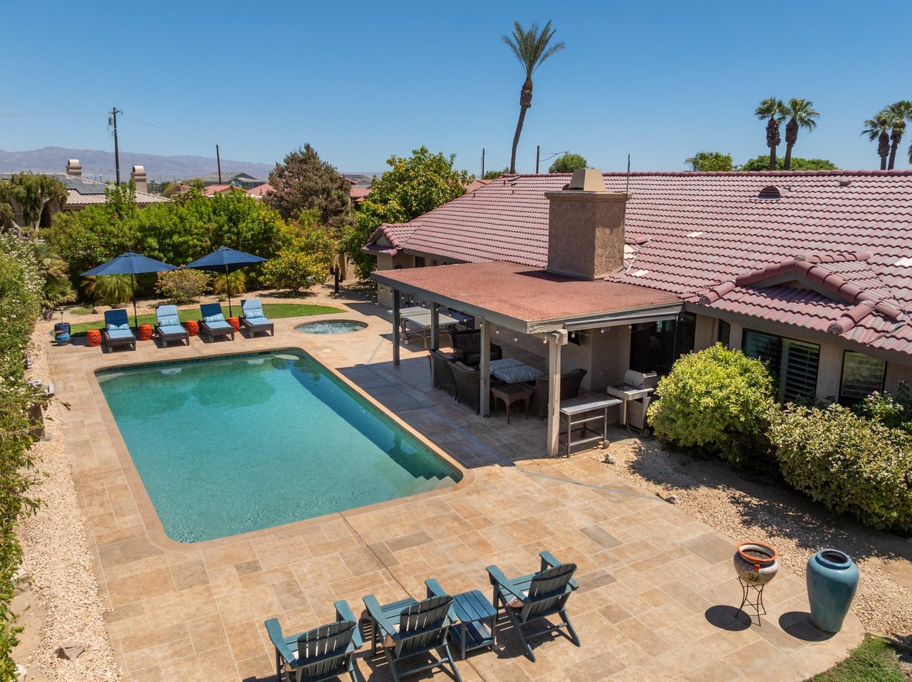 Backyard with private pool, hot tub, ping pong table and covered patio.