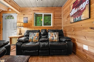 Loveseat in the living room at License to Chill, a 3 bedroom cabin rental located in Gatlinburg