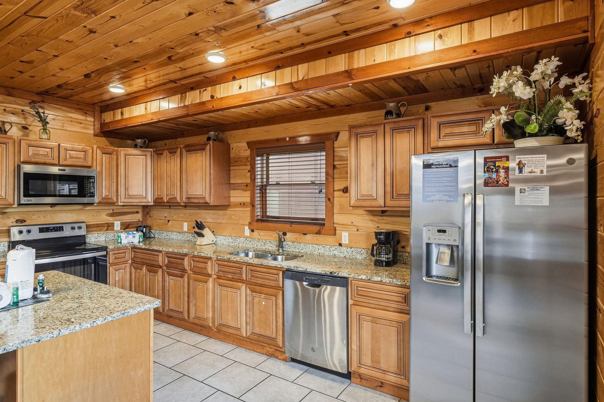 Your fully equipped kitchen features granite countertops, stainless steel appliances, and warm wood cabinetry—perfect for preparing memorable meals together.