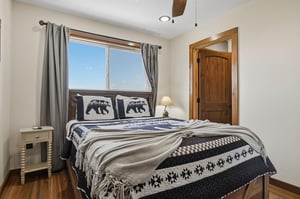 Sink into your cozy retreat and let the natural light brighten your mornings. This inviting bedroom sets the perfect tone for restful nights after days of mountain adventure.