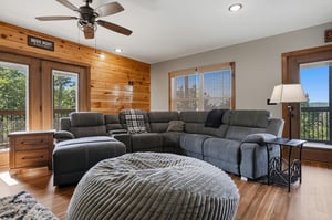 Settle into plush sectional seating and lose yourself in your favorite film. Natural light streams through surrounding windows, while your mountain vista awaits just beyond.
