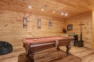 Challenge friends to pool in your private game room, featuring rustic wood walls and vintage pub decor.
