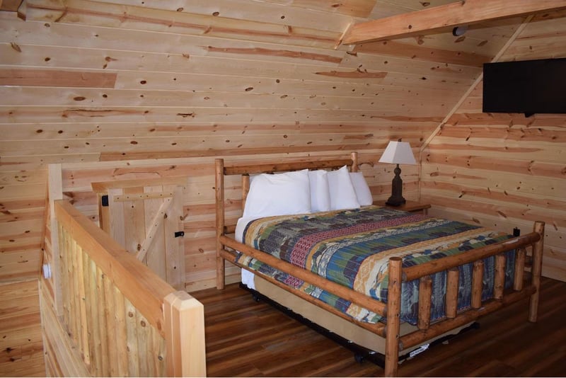 Cozy up in your rustic log cabin bedroom featuring handcrafted wood furnishings and charming exposed beam ceilings.