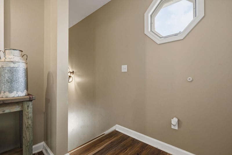 Natural light streams through the skylight above, illuminating this cozy nook with warm hardwood floors and a touch of rustic charm.