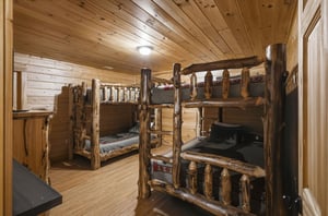Cozy up in this rustic bunk room where handcrafted log beds create the perfect mountain retreat for your group adventure.
