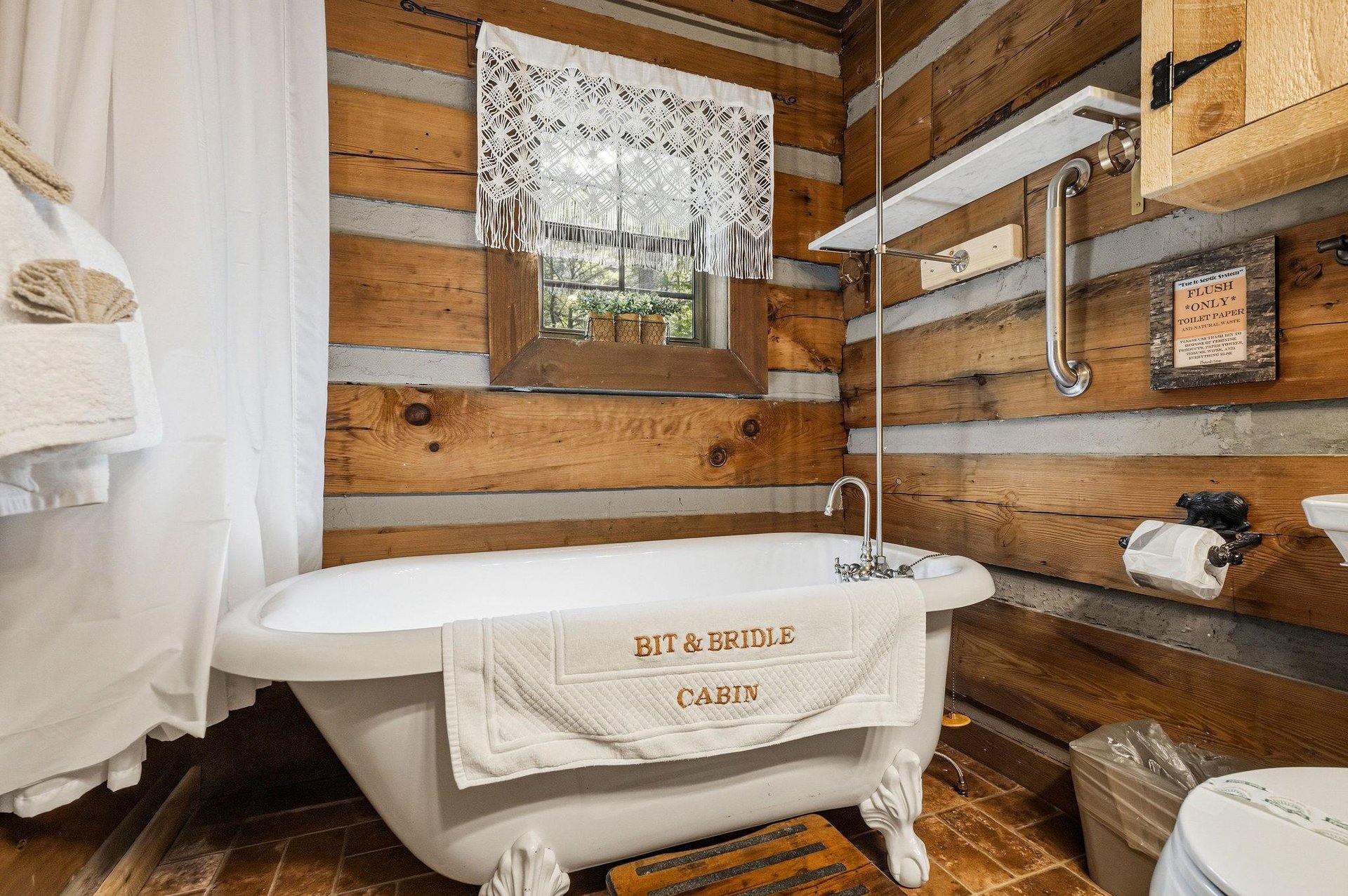 Unwind in your private vintage clawfoot tub surrounded by rustic cabin charm, where warm wood walls and handcrafted touches create a serene retreat just for you.