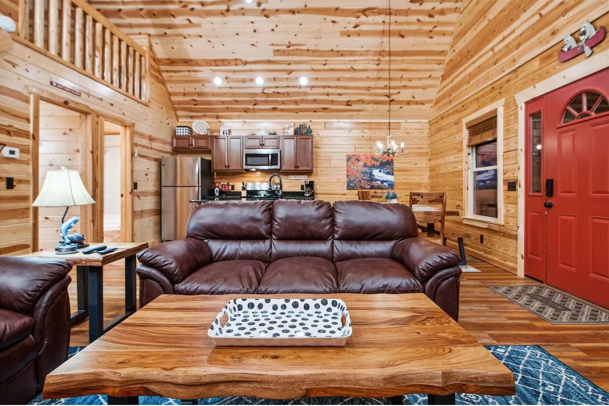 Sink into plush leather seating in your rustic cabin where warm wood surrounds you and the open kitchen awaits your culinary adventures.