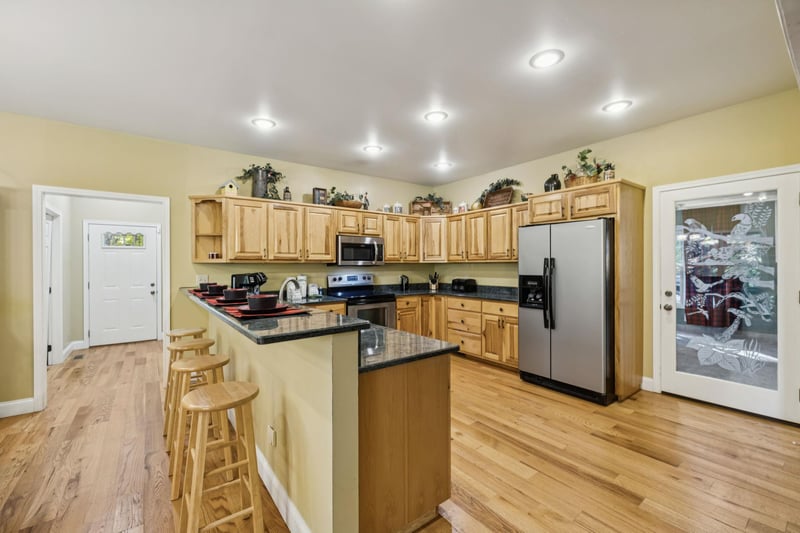 Step into your fullyequipped kitchen with warm wood cabinetry, granite countertops, and stainless appliances—perfect for preparing family meals or morning coffee before your adventures.