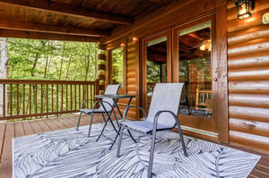 Sink into a chair on your private deck, surrounded by lush woods. Feel the forest breeze as you sip morning coffee or unwind beneath the warm glow of rustic cabin charm.
