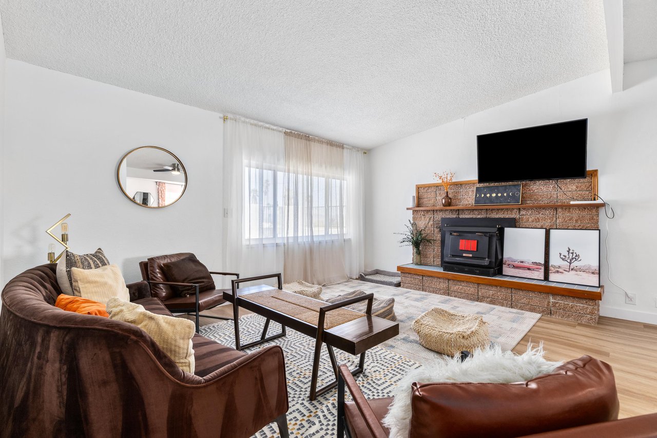 Flatscreen TV, wood stove, and ample seating.