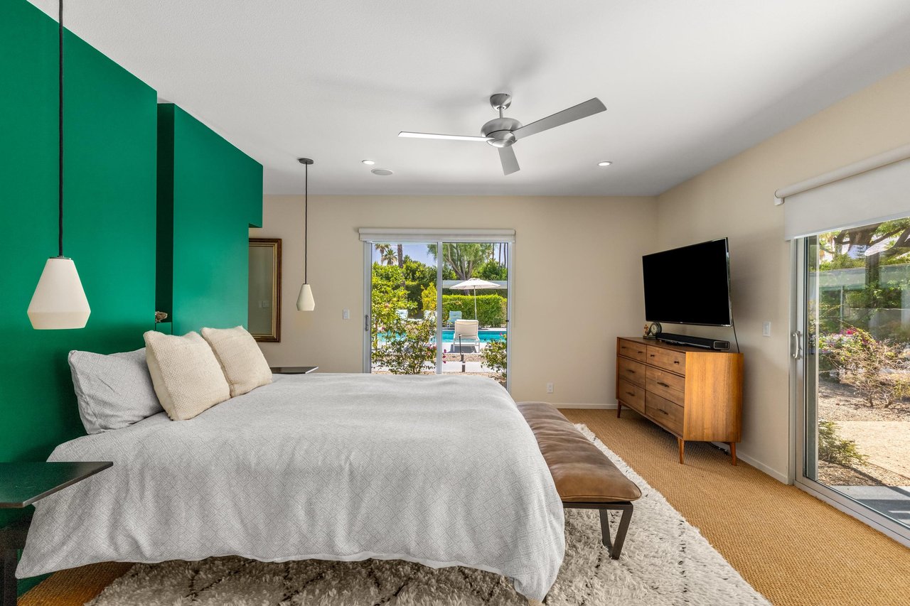 Features a queen size bed, sliding doors that access the poolspa and back patio, smart TV, and ensuite bathroom.